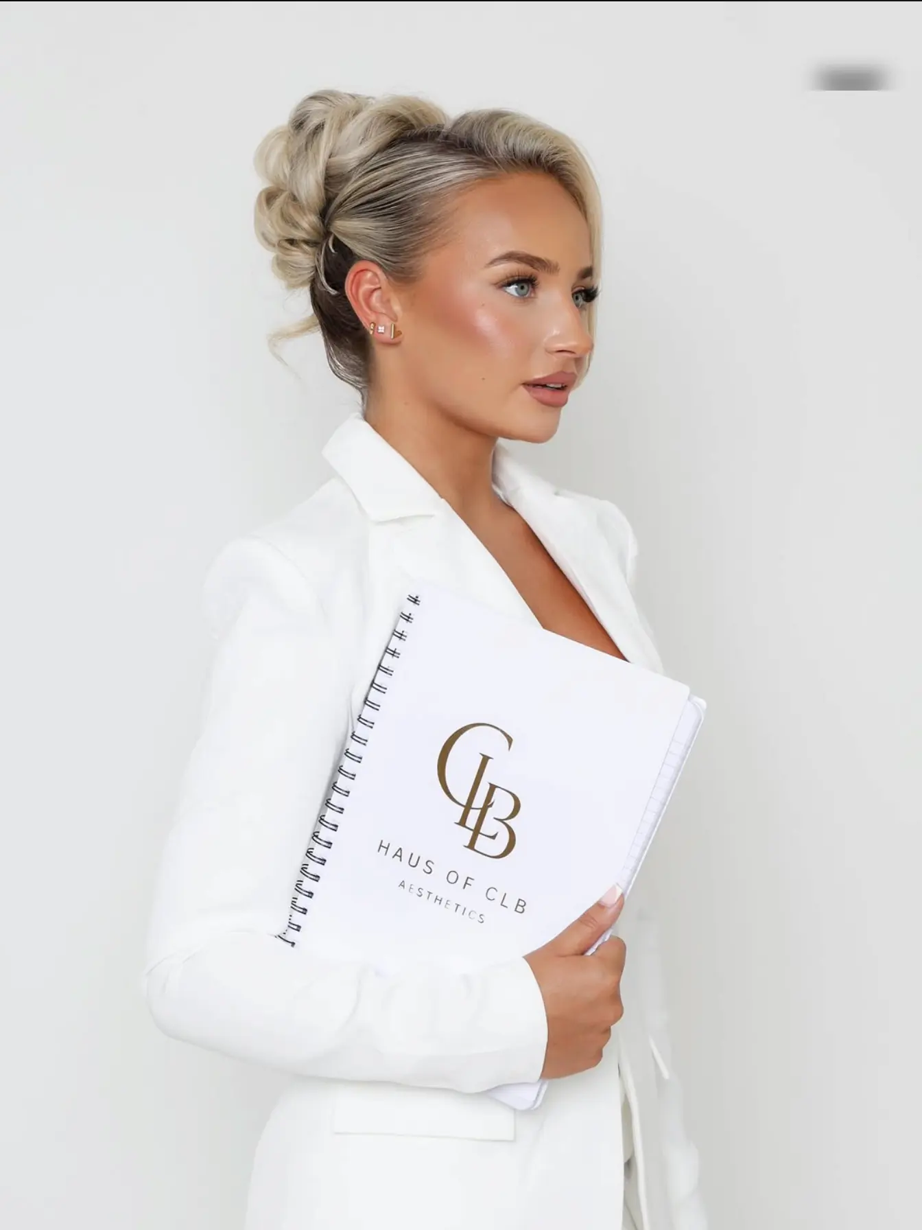 Nurse Charlotte holding the Haus of CLB consultation notes